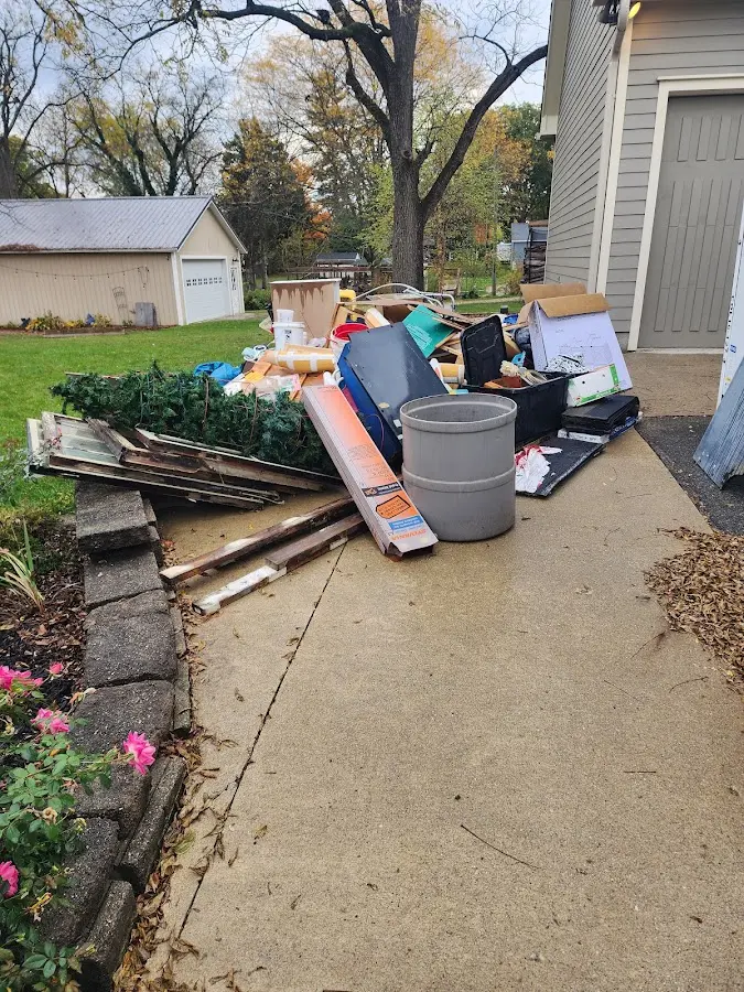 Dumpster being loaded with debris for Estate Cleanout Dumpster Rental in Fredericktown